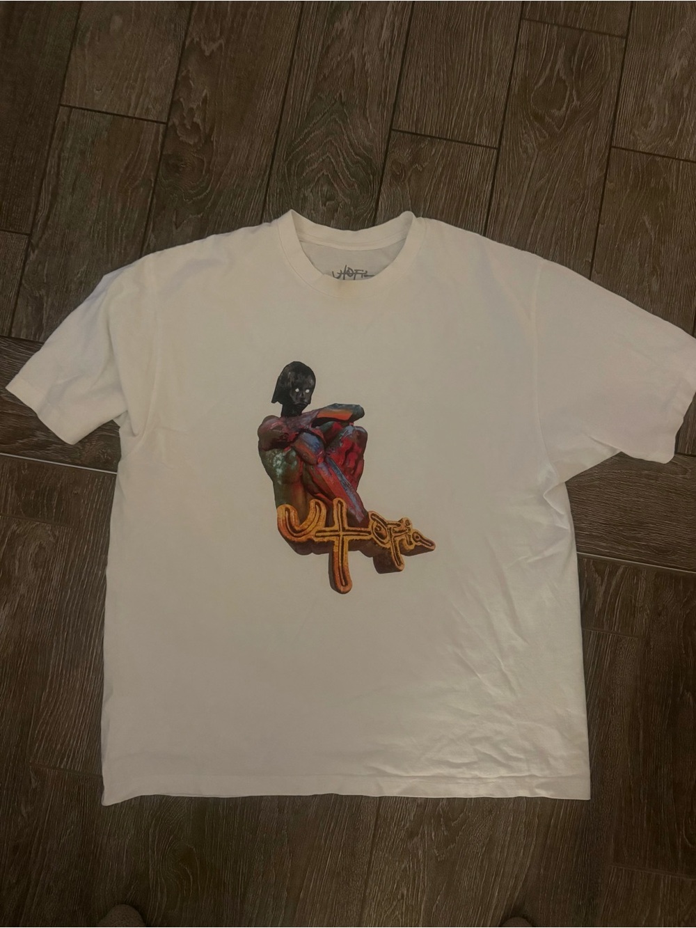 Travis Scott -Undefeated Graphic Tee with Multicolor Figure & Gold Logo